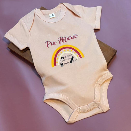 Babybody in rosa, bedruckt mit einem bunten Regenbogen, Namen, Geburtstag, Geburtsgewicht, Geburtsgröße, Geburtsuhrzeit